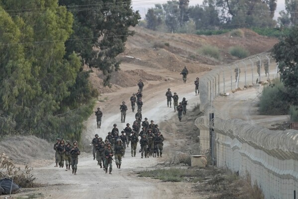 Israeli soldiers patrolling near Kibbutz Be'eri, Israel, Wednesday, Oct. 11, 2023. The kibbutz was overrun by Hamas militants from Neraby Gaza Strip Saturday when they killed and captured many Israelis. (AP Photo/Ohad Zwigenberg)
